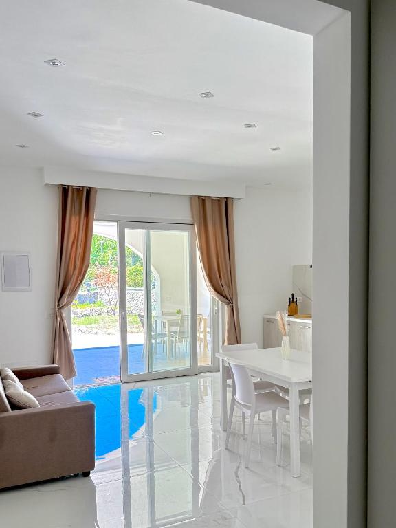 a white living room with a white table and chairs at Luxury Magre in Ischia Town