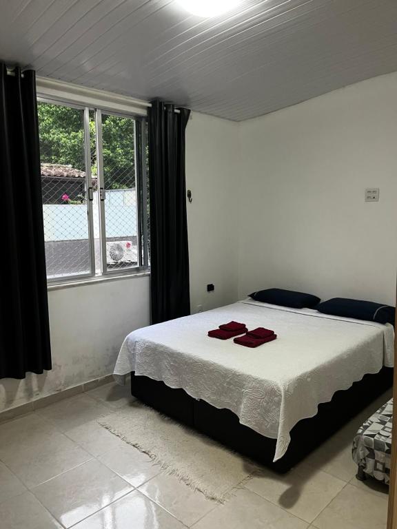 Ένα ή περισσότερα κρεβάτια σε δωμάτιο στο Vila quartos LemeCopa