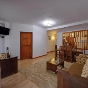 a living room with a couch and a table at Cloudberry Inn Vibe in Nuwara Eliya