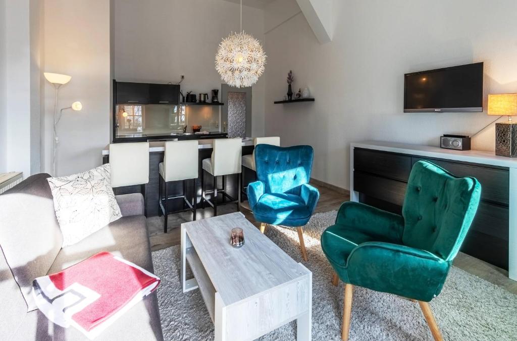a living room with a couch and chairs and a table at Kietz-Quartier mit Balkon & Müritzblick im historischen Speicher in Waren