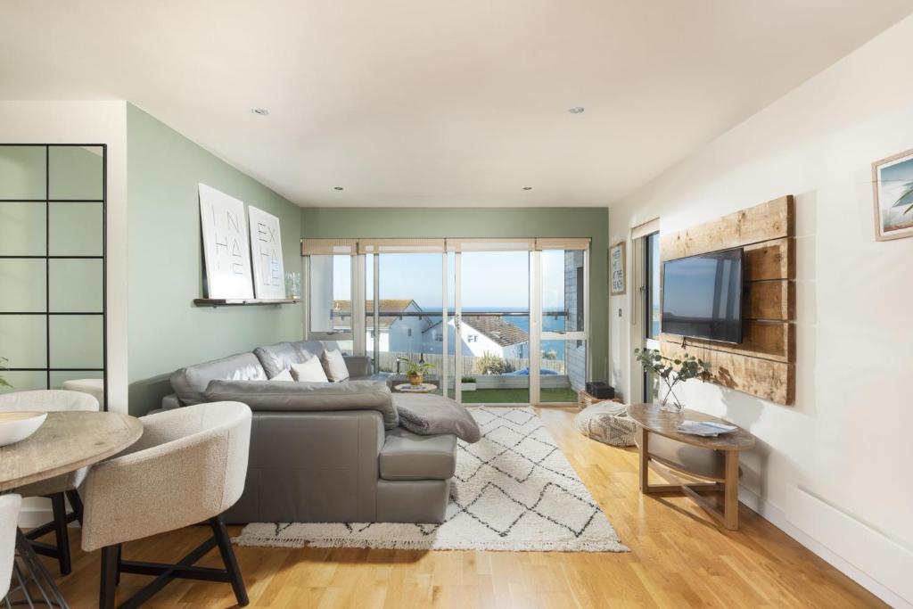 a living room with a couch and a table at 6 The Point - Walk to Newquay's Beaches - Free WiFi and Parking in Newquay