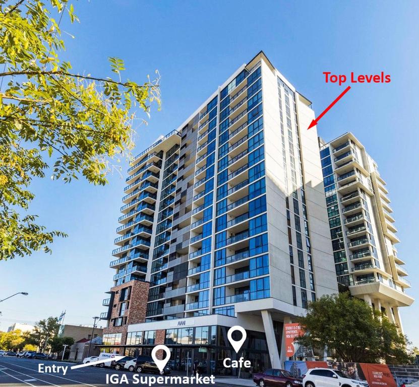 ein hohes Gebäude mit einem roten Pfeil darauf in der Unterkunft CBD Resort with King Suite, Pool, Gym, Sauna, Cafe, Wifi, IGA in Adelaide