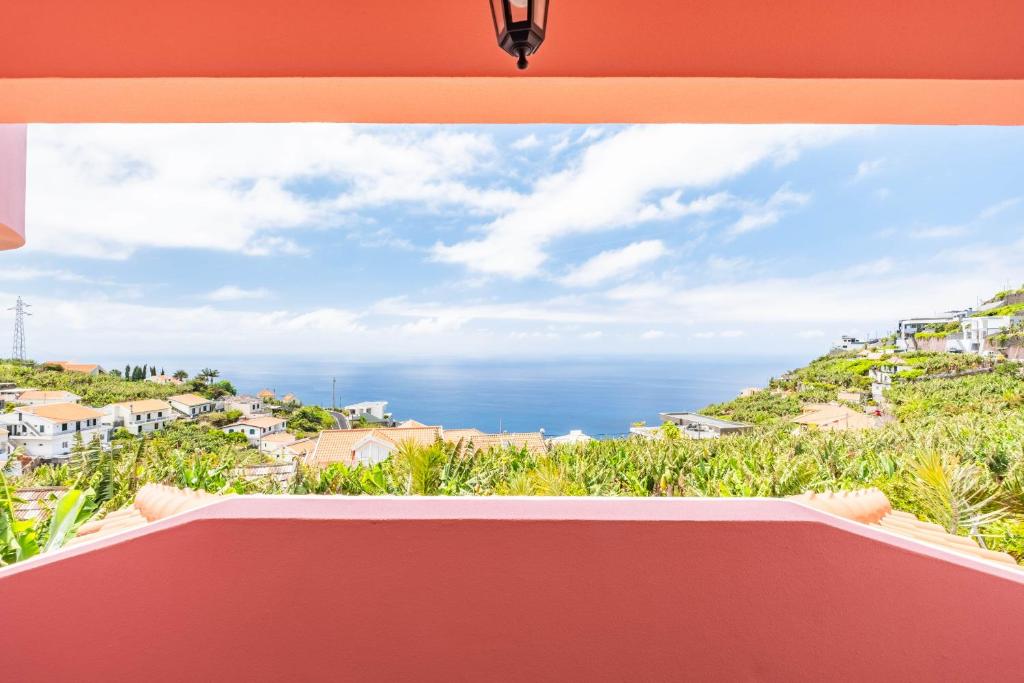a view of the ocean from the balcony of a house at Amendoeira Residence by Homie in Quinta do Almeida