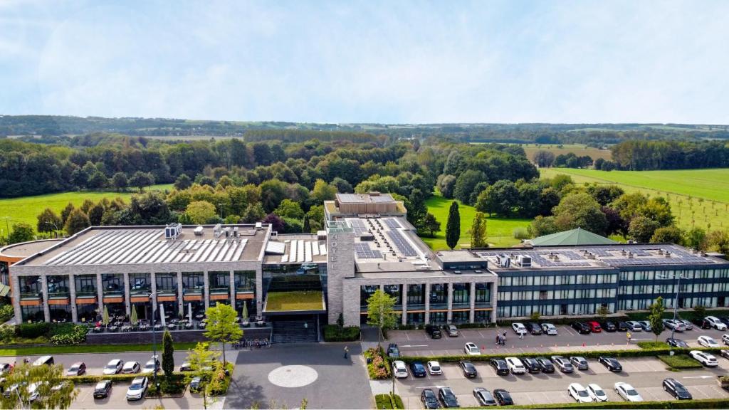an aerial view of a building with a parking lot at Van der Valk Hotel Heerlen in Heerlen