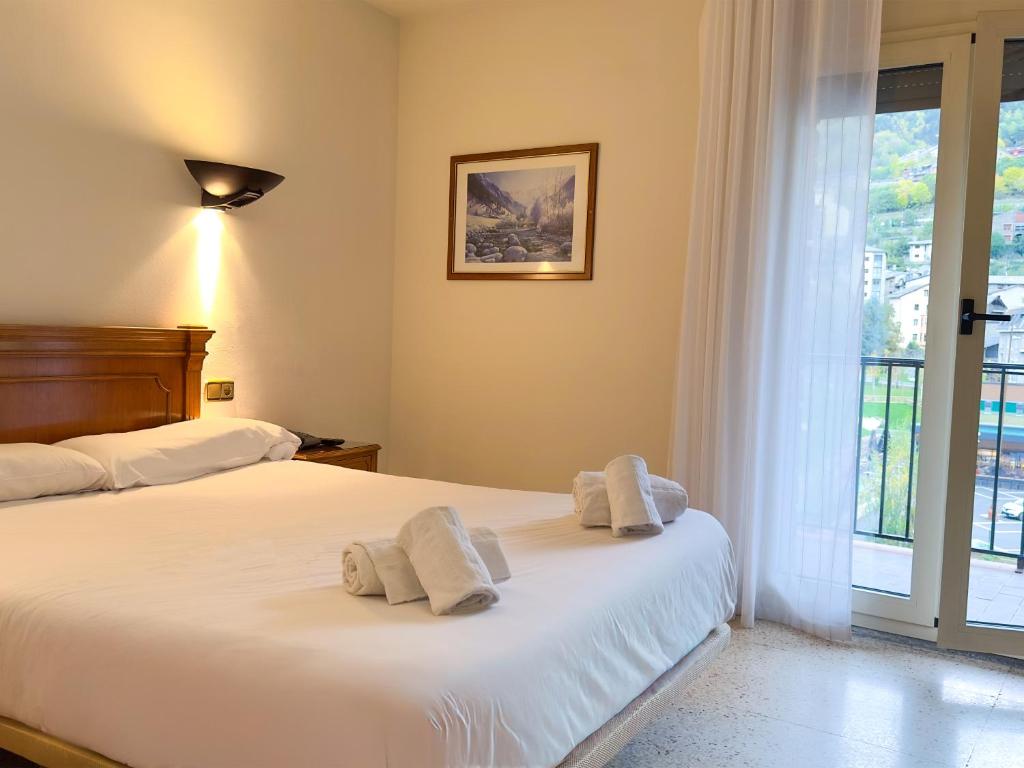 Postel nebo postele na pokoji v ubytování Hotel Pere D'Urg 3000