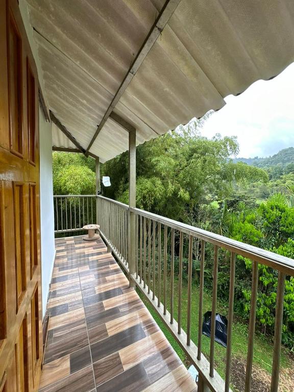 a porch of a house with a wooden deck at Paisaje Andino Salento in Salento