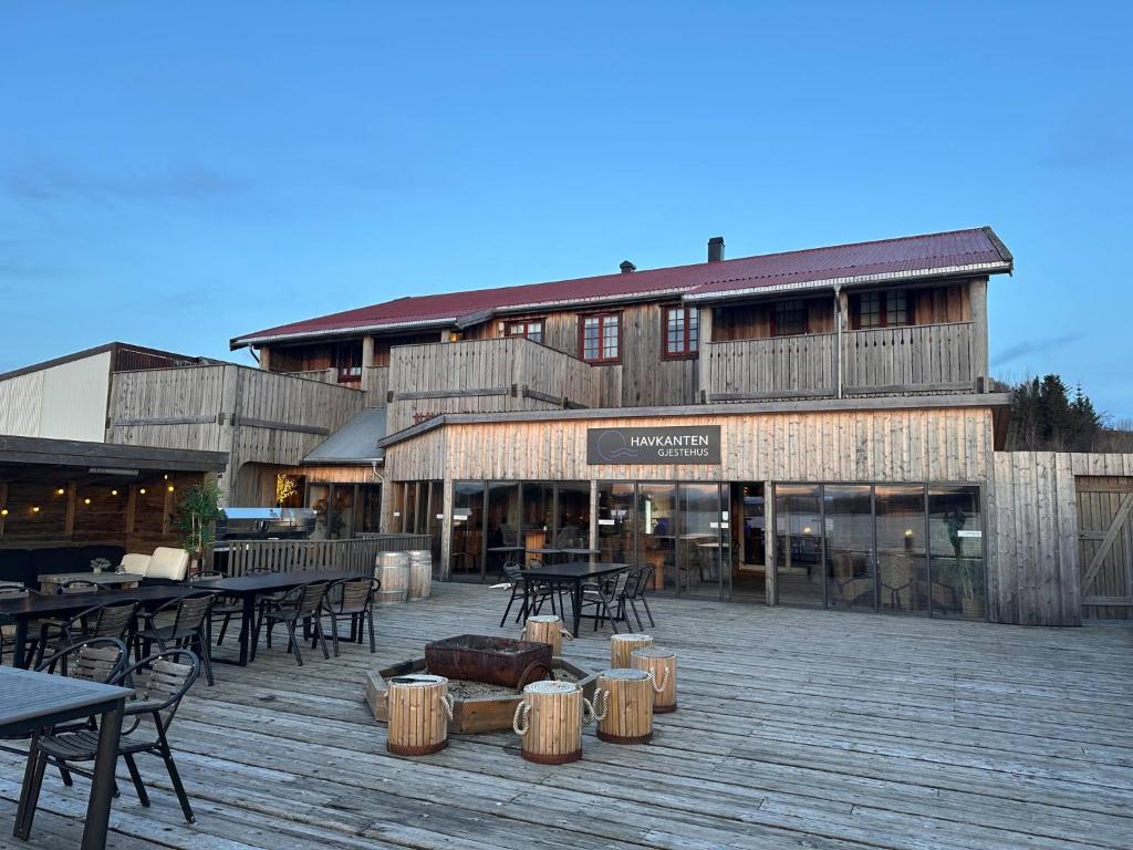 a large building with tables and tables and chairs at Havkanten Gjestehus in Husvær