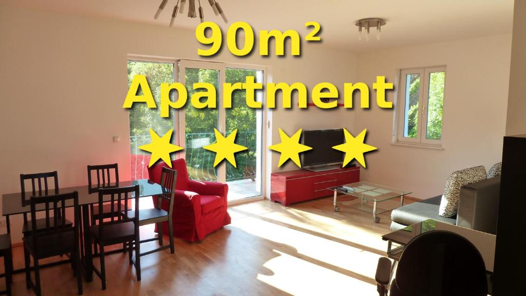 a living room with red chairs and yellow stars on the wall at Apartment Vindobona in Vienna