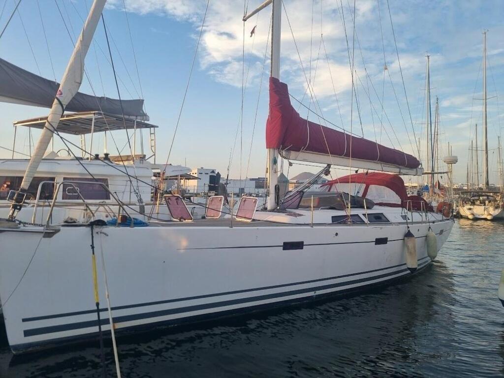 a white boat is docked in the water at LUNA BAY, voilier 3 cabines 2 sdb en ville in Sète