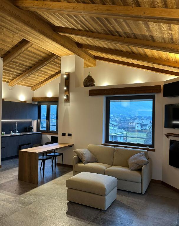 a living room with a couch and a table at Valtellina SkyLine EST in Villa di Tirano