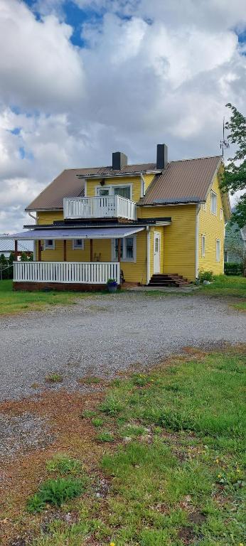 a yellow house with a white fence in front of it at Omakotitalo Pirintie 22, Härmä in Kauhava