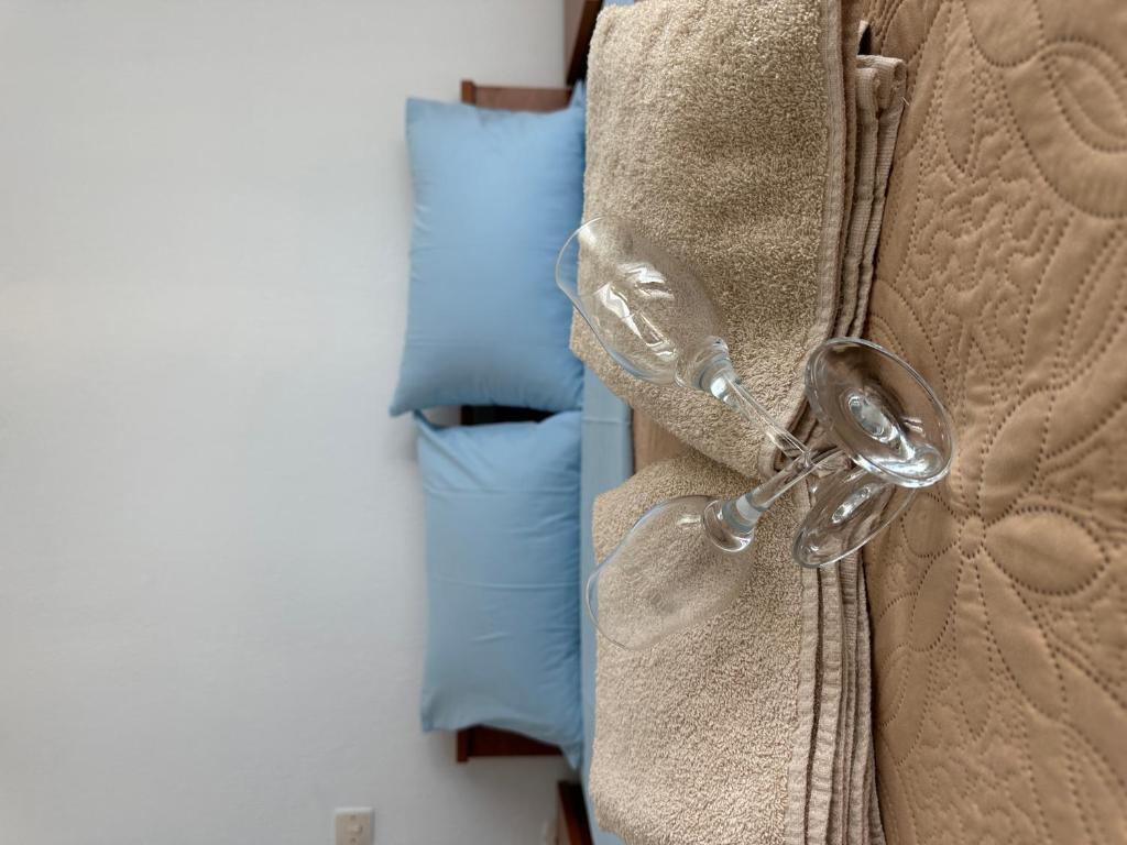 a magnifying glass on the side of a bed at Near Sea Studio in Paralia Katerinis