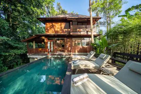 a house with a swimming pool in front of a house at Villa Seremi in Bedahulu