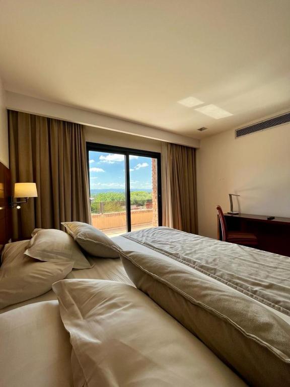 Postel nebo postele na pokoji v ubytování Neper Hotel