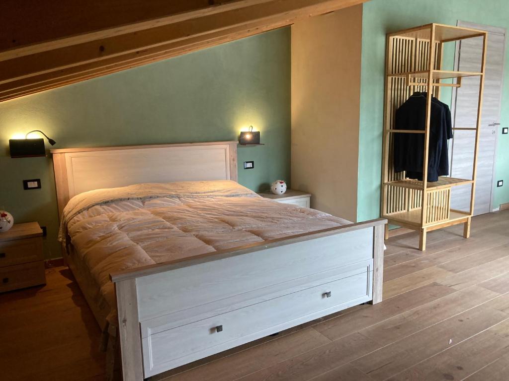 a bedroom with a large bed and a mirror at Ca' Celeste sul Garda in Costermano sul Garda