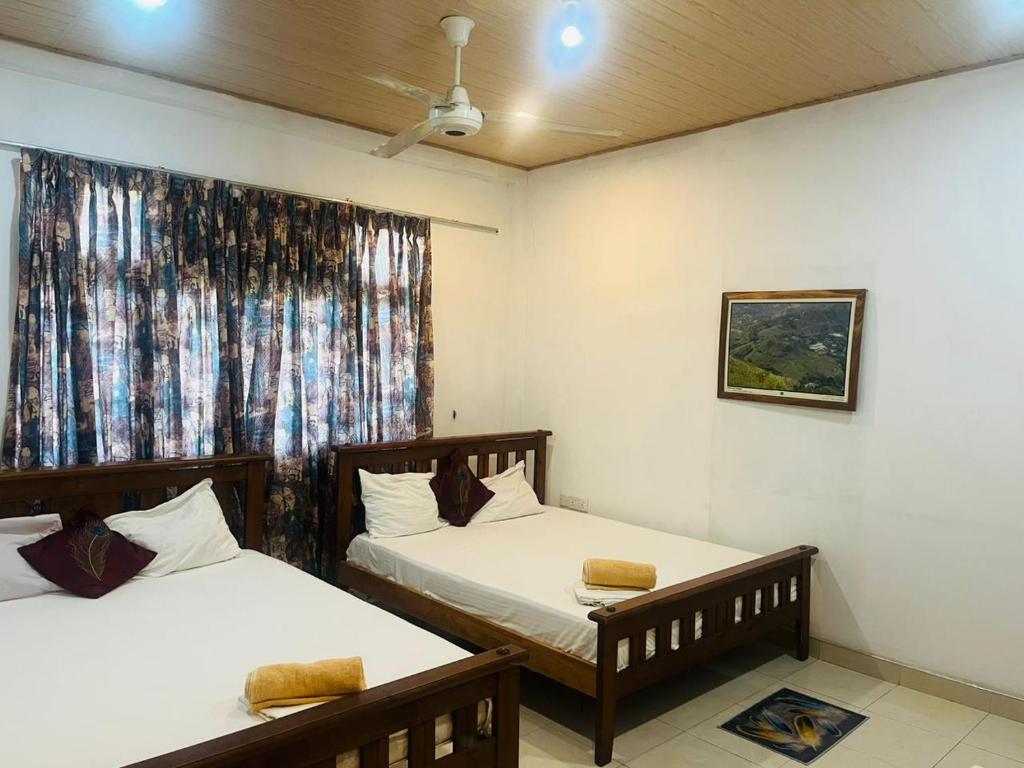 Postel nebo postele na pokoji v ubytování Suisse View Residence Kandy