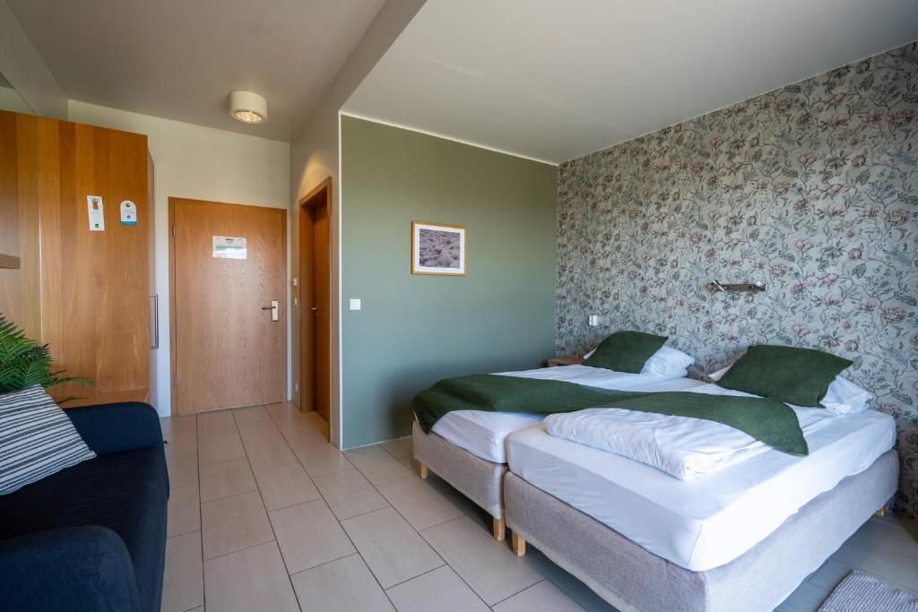 Postel nebo postele na pokoji v ubytování Hotel Laki