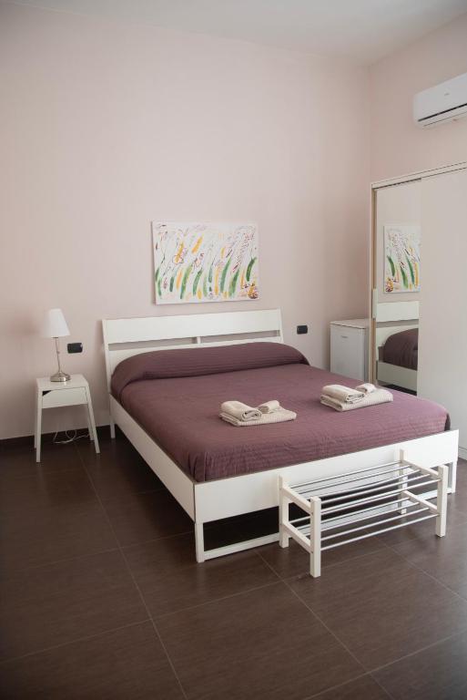 a bedroom with a bed with a purple bedspread at la dimora di Venere in Gaeta