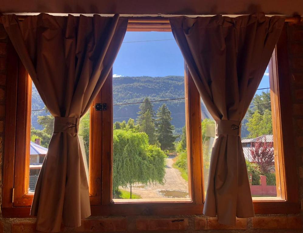 a window with a view of a mountain view at Cabaña Trabun Lago Puelo in Lago Puelo