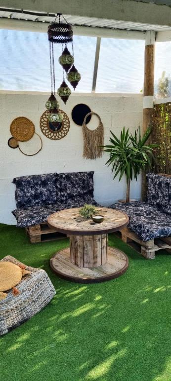 un salon avec une table et un canapé dans l'établissement Ty Grain de Sel : logement privatif avec piscine, jardin et patio, à Chauvé