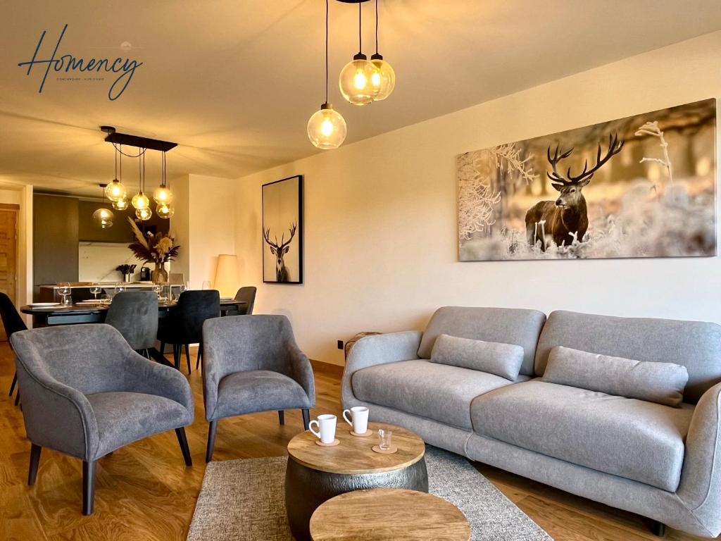 un salon avec un canapé et des chaises dans l'établissement Homency - Résidence Cachemire A304, à L'Alpe-d'Huez