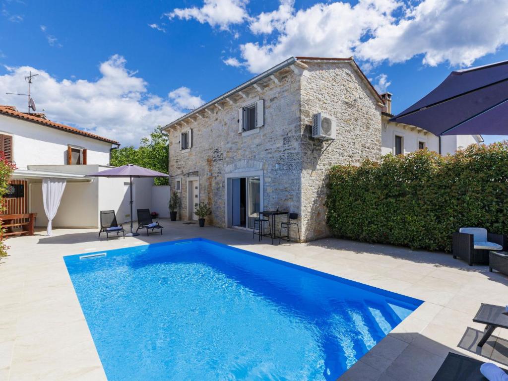 a swimming pool in front of a house at Holiday Home Villa Karmen by Interhome in Sveti Petar u Šumi