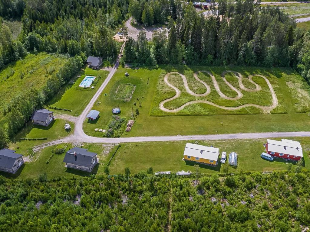an aerial view of a farm with a swirl in the grass at Holiday Home Tuisku by Interhome in Punkalaidun