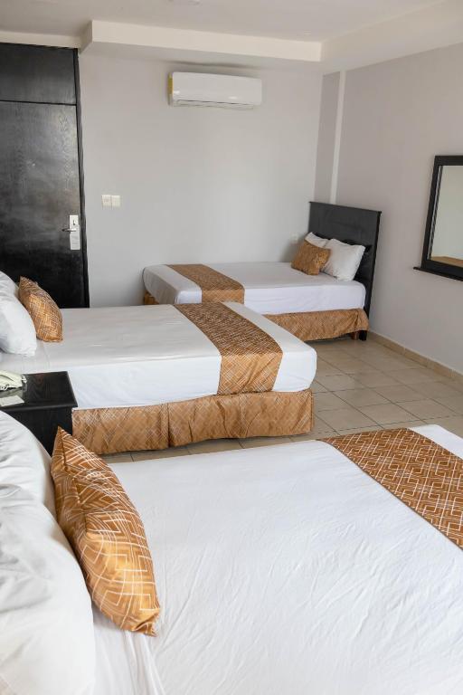 Postel nebo postele na pokoji v ubytování Hotel Costa Verde