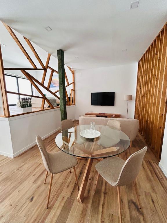 a living room with a glass table and chairs at Aires de Valencia - Spacious 2-Bedroom Apartment in Valencia