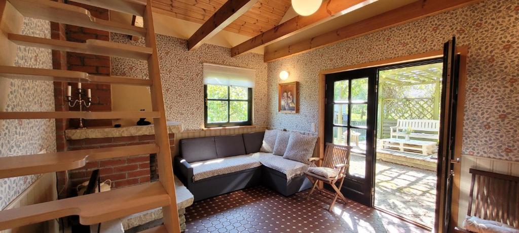 a living room with a couch and a window at Nurmenuku suvemaja in Tallinn