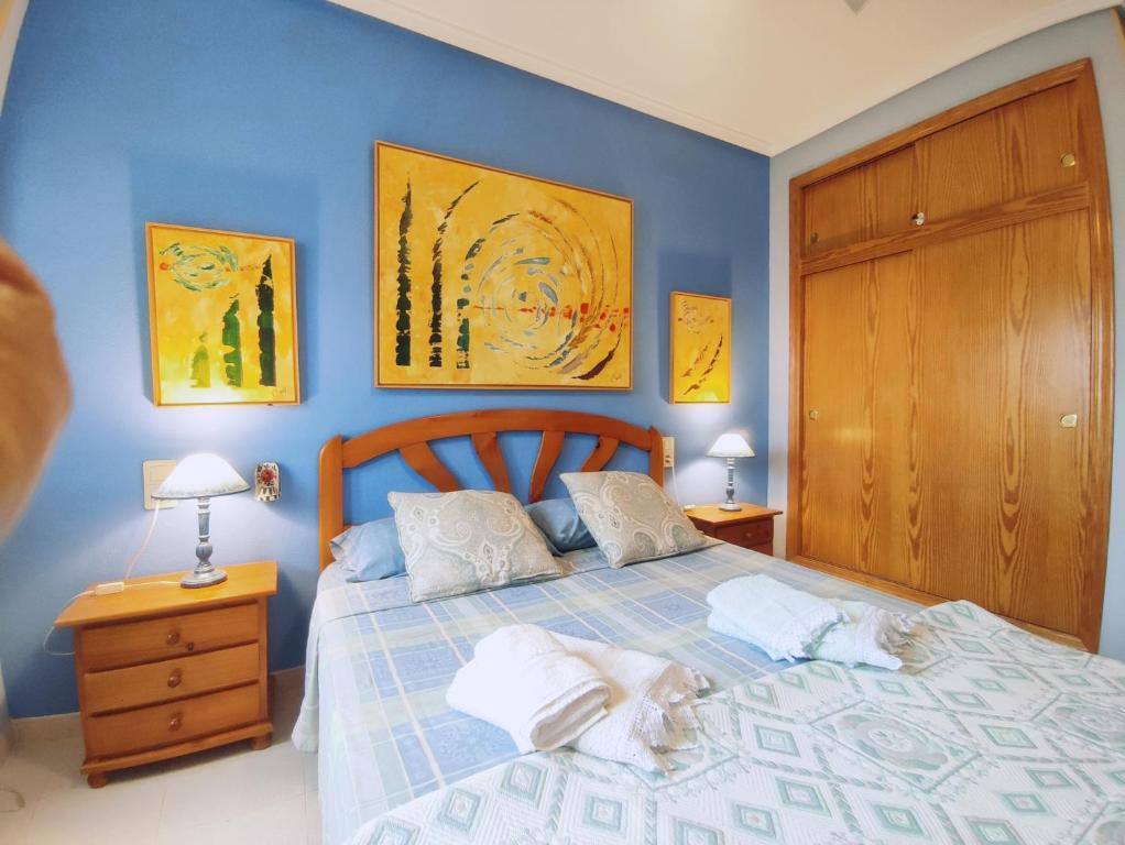 a bedroom with a bed with two towels on it at Arenales del Sol Vista Bahía in Arenales del Sol