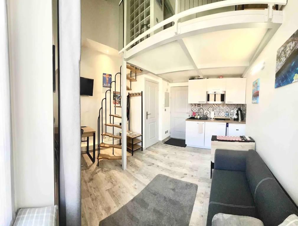 un salon avec un canapé et une cuisine dans l'établissement Appartement moderne & calme proche mer et centre, à Nice