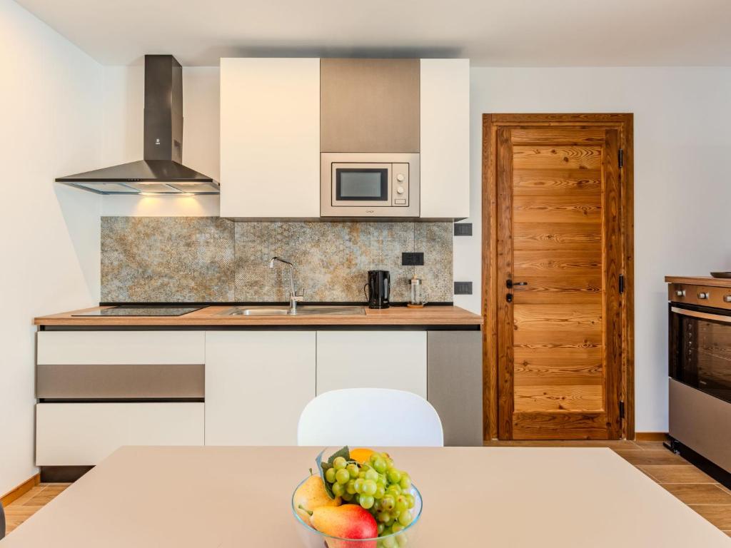 a kitchen with a bowl of fruit on a table at Apartment Martin Pescatore by Interhome in Verceia