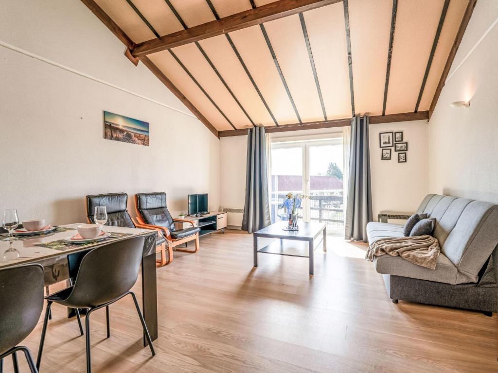 a living room with a table and chairs at Apartment Zeewind II A 11 by Interhome in Bredene
