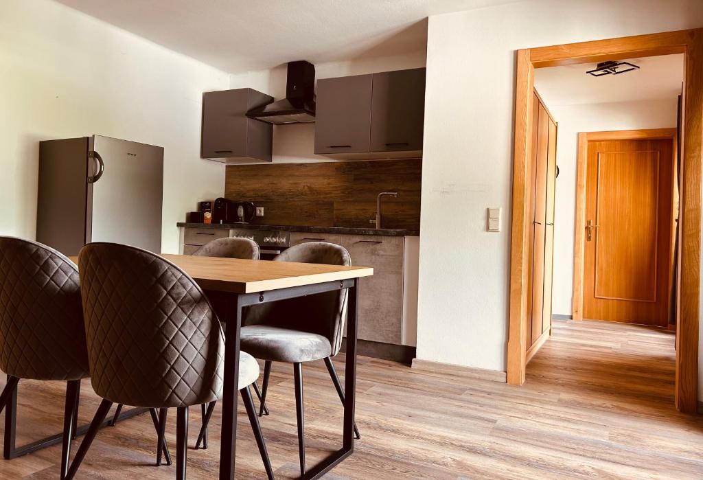 a kitchen with a wooden table and chairs at Appartment Marcher in Kaprun