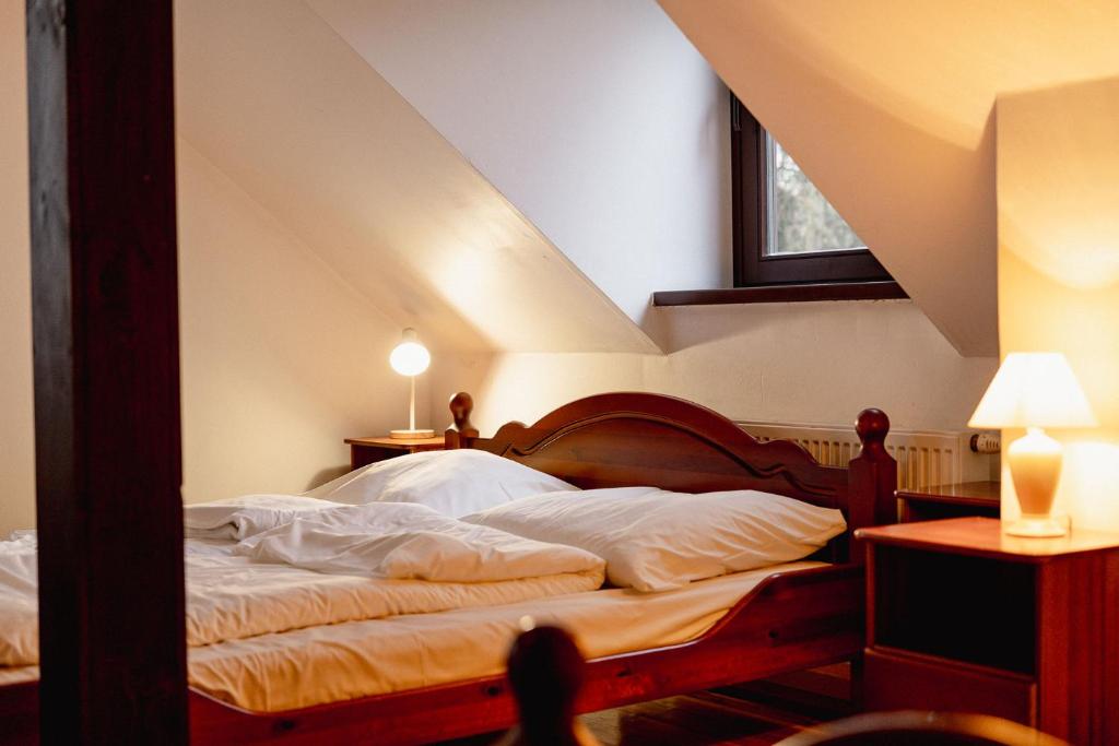 a bedroom with a bed in a attic at Pod Kogutem in Cierzpięty
