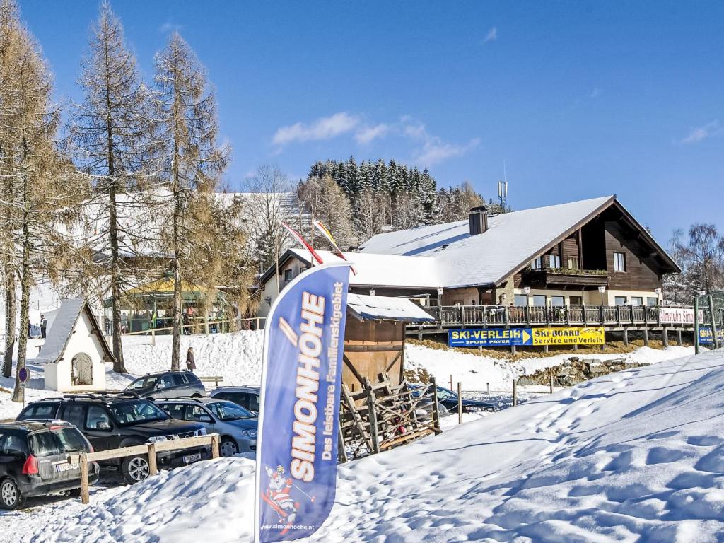 a snowboard in the snow in front of a lodge at Apartment Maisonette by Interhome in Sankt Paul
