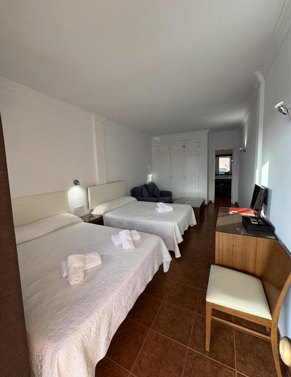 Postel nebo postele na pokoji v ubytování Hotel Las Camelias