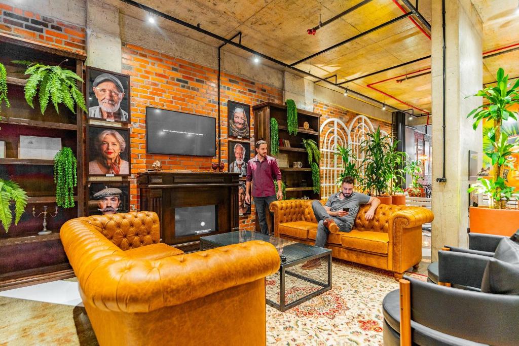 Televiisor ja/või meelelahutuskeskus majutusasutuses Linked Batel by Xtay - Experiencia moderna e conectada a passos do Hard Rock