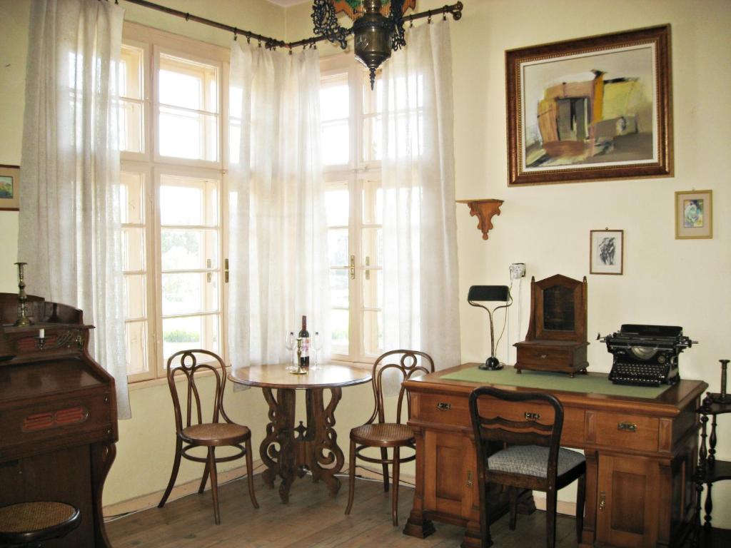 プロブディフにあるMaritsa River Apartmentのテーブルと椅子、窓が備わる客室です。