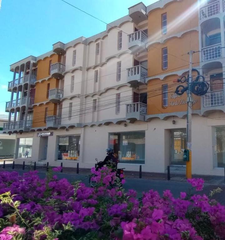 a building with purple flowers in front of it at Flowers House Aptos - Centro Histórico in Valledupar