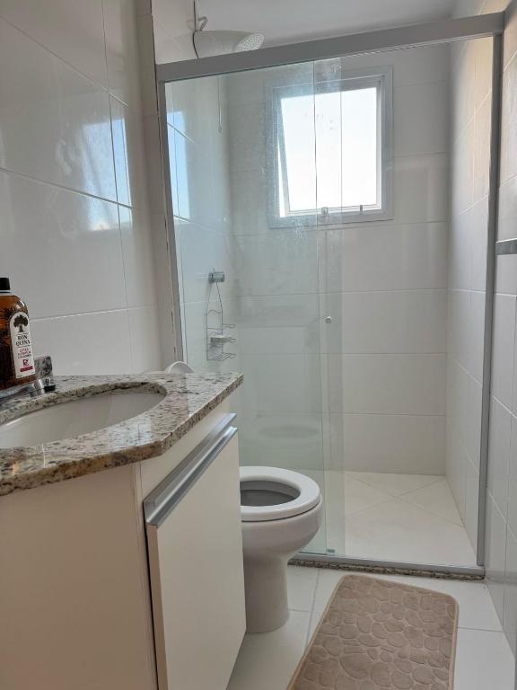 a bathroom with a shower and a toilet and a sink at Aruana - Diamante in Aracaju