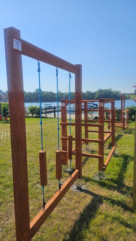 a wooden fence with a view of the water at Hawiry Nad Dylą in Głębockie Pierwsze