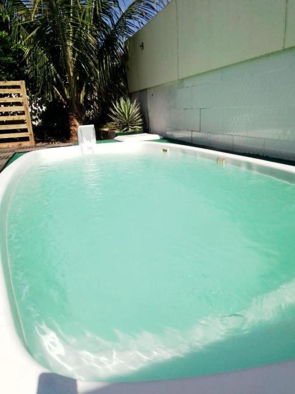 a large blue bath tub sitting next to a building at Itaipuaçu Central in Maricá