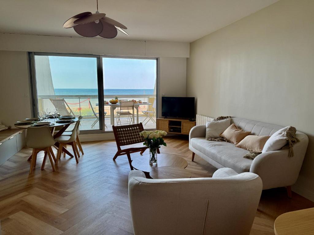 un salon avec un canapé et une table dans l'établissement Les Iles Bauloises, à La Baule