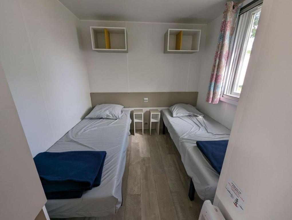 a small room with two beds in it at Camping de Lanven in Plomeur
