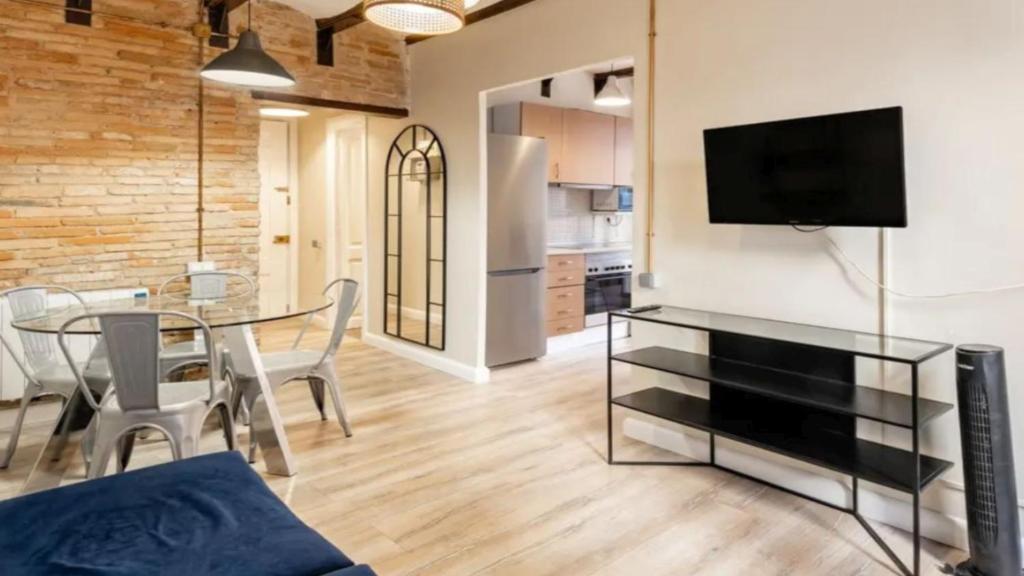 a living room with a table and a tv on a wall at Seaview Villa in Apollonii Lefkada in Athanion