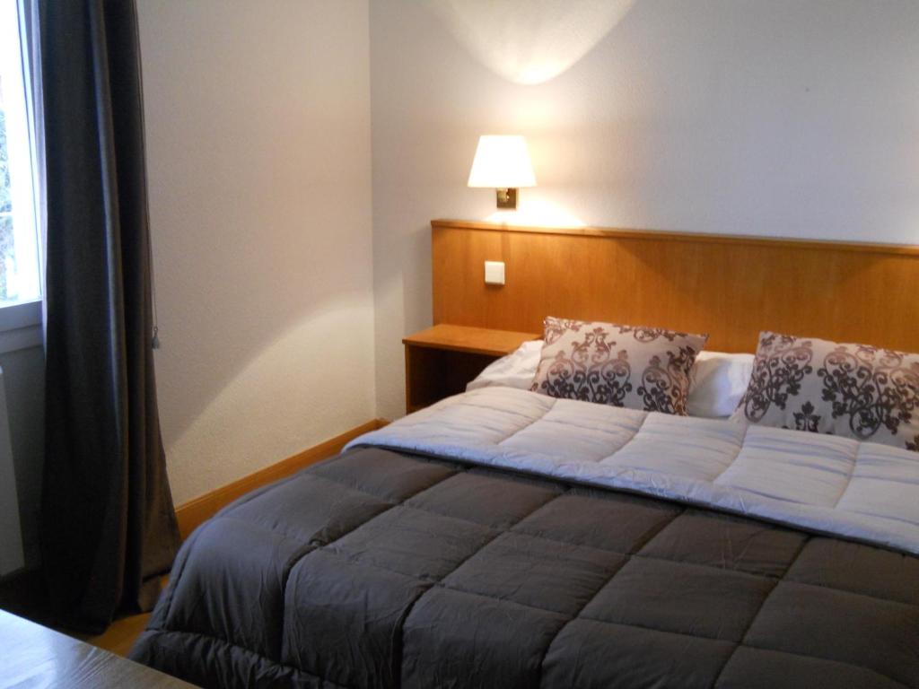 Postel nebo postele na pokoji v ubytování Hotel Elizondo