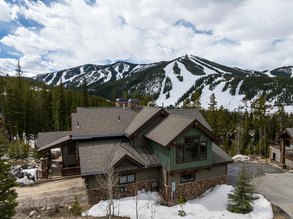 a house with a mountain in the background at Dreamcatcher a spacious Five bedroom home in Winter Park Colorado in Winter Park