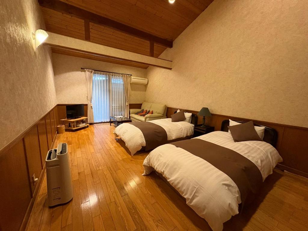 Postel nebo postele na pokoji v ubytování 平山温泉　奥山鹿温泉旅館